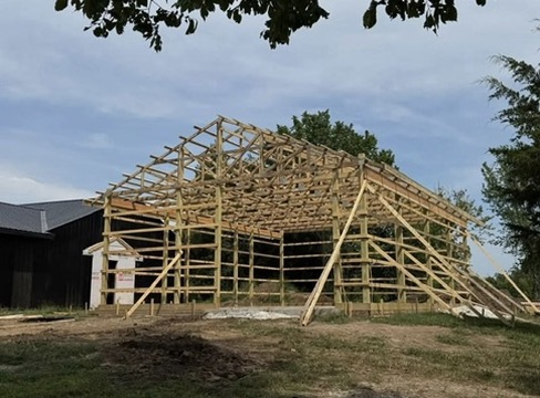 Timber frame of a pole barn under construction